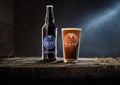 Ramsbury Brewery Farmer's Best bottle and pint glass with light shining through.